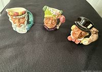 All three miniature character jugs grouped together