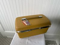 Full view of mustard yellow Samsonite Saturn train case closed, showing shape and colour