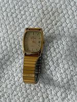 Front view showing case shape, dial, markers, date window, and band