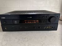 Front angled view of Yamaha RX-V730 receiver powered on