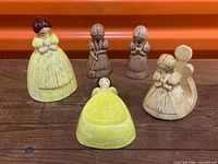 Group shot of all five ceramic corn-husk girl pieces