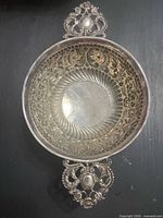 Top view showing pierced decorative filigree and one handle