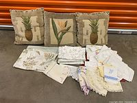 Overall lot with three decorative pillows and spread of assorted linens