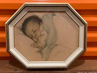 Full view of framed sleeping baby print