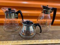 All three glass carafes together beside ruler for scale