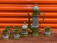 full set showing coffee pot, sugar bowl, creamer, six mugs visible