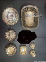 All eight silver-plated items laid out