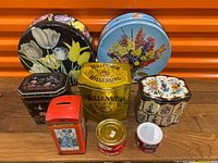 Group shot of all eight tins