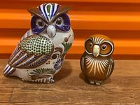 Front view of both owl figurines showing painted detail and relative sizes