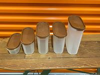 set of five stacked Tupperware containers with lids attached