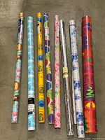 All eight rolls laid side by side showing full designs and lengths