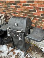 Front view of Sterling propane BBQ showing lid, controls and side shelves