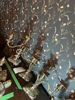 Two three-light and one two-light silver-plated candelabras on table