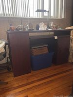 Front view of dark wood office desk with cabinet and open shelf