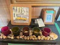 Full lot view showing candle tray with five votive holders, Lisboa tile trivet, framed stamp, and surrounding items