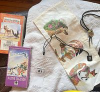 Overview of bolo tie, VHS tapes, linen panel and blanket