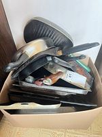 Box showing assortment of pans and trays