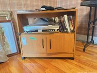 front view showing upper shelf, cabinet doors, wheels