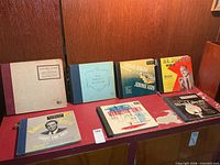 All seven 78 RPM album books standing on shelf