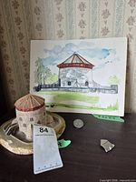 Watercolour painting, figurine, detached chip, coin for scale