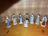 All seven figurines lined up on shelf