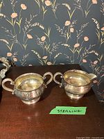 Sterling silver sugar bowl and creamer on tabletop