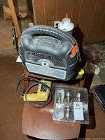 Overall lot showing sander case, drill, door knob package, scrapers