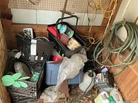 Overall view of bins, hose, sprayer, cords and assorted items