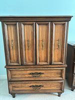 Front view showing paneled doors and two drawers