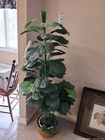 Full view of artificial fiddle leaf fig plant in decorative pot