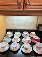 Group shot of 12 assorted teacup and saucer sets