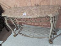 Front view of console table showing metal frame, marble top and wire shelf