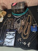 Overview of all jewelry pieces laid out with chest style jewelry box