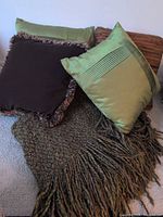 Brown fringed cushion, green cushion, fringed throw