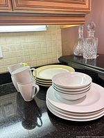 Group of Denby white mugs, bowls, plates with caramel rim plates