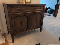 Front view of wood server showing drawer, double doors, legs