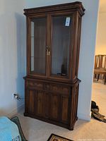 Full view of cabinet front showing upper glass doors and lower storage