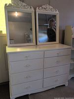Front view of white 8-drawer dresser with two mirrors on top