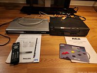 Both players, remote, manuals and cables on floor