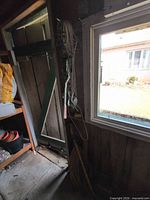 Overview showing extension cord on holder and come-along mounted to wall