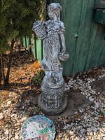 Full view of statue on pedestal showing overall condition and design