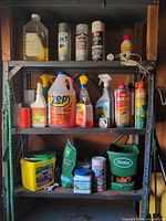 Full shelving unit showing all chemicals, fertilizers and spreader