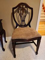 Front view showing lyre back design, seat upholstery and front legs