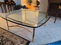 Oblique view showing glass top and brass base