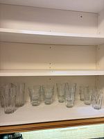 Cupboard shelf showing all glasses grouped by size