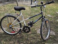 Left side view of full bicycle showing frame, wheels, rack, horn and bottle