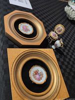 Two framed miniature plates and three porcelain miniatures visible