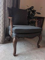 Full view of chair front showing wood frame, cushions, legs
