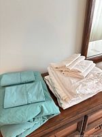 Both sheet sets folded on dresser