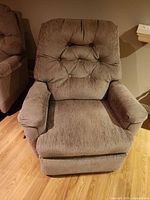 Front view of grey-brown button-tufted fabric rocker recliner